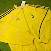 Picture of Real Madrid 2024 Double Sided Jacket Black & Red/Yellow